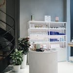 Contemporary beauty store interior showcasing various cosmetics on elegant shelves.