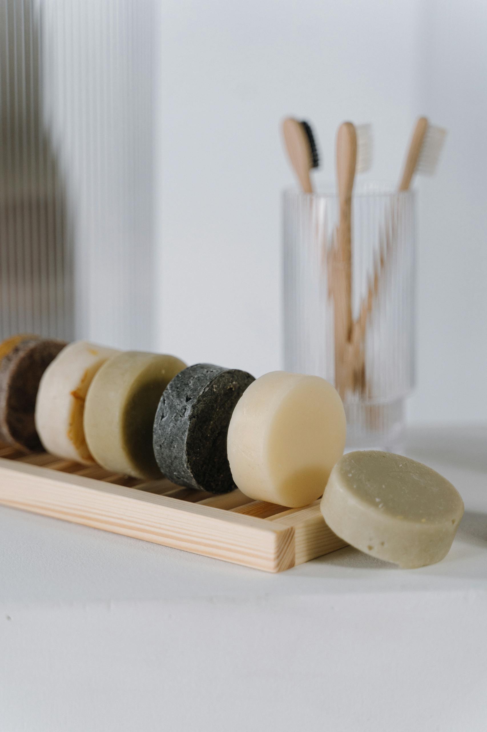What is sustainable beauty: eco-friendly solid soap bars and bamboo toothbrushes representing sustainable personal care
