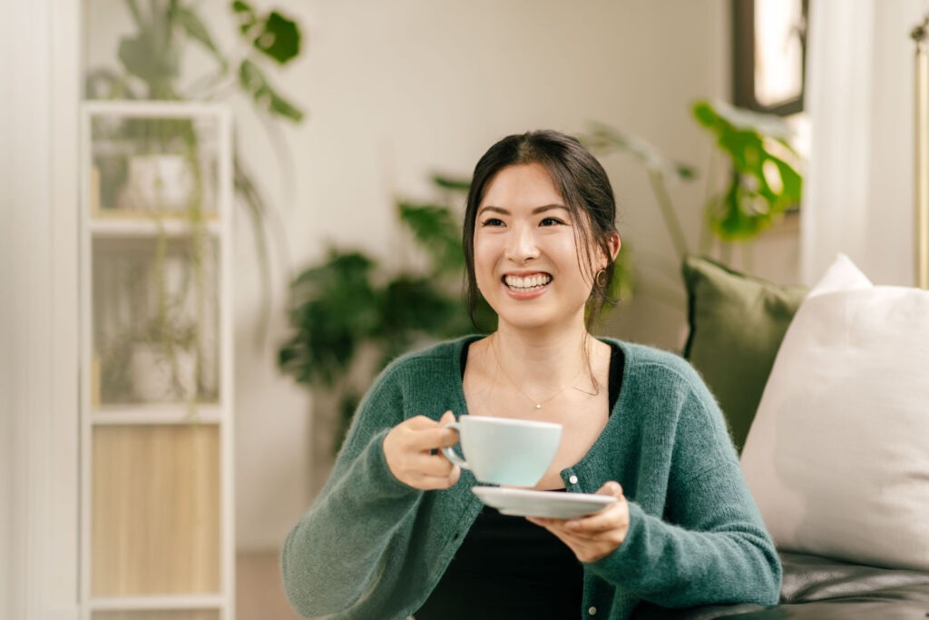 Woman holding a cup of tea or coffee.
